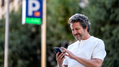 Home amb un telèfon mòbil a la mà.