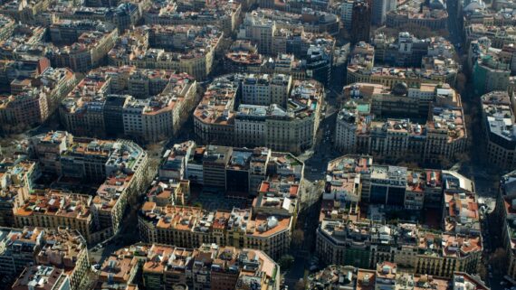 Vista aèria panoràmica de les illes de cases de l'Eixample, on s'aprecia la quadrícula del Pla Cerdà. Al fons, la Torre Urquinaona, edifici d'estil brutalista